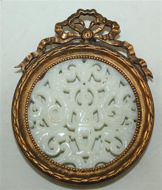 A Chinese white hardstone plaque, diam. 7.6cm